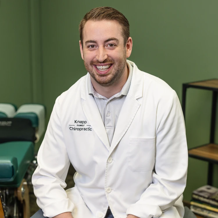 Dr. Connor Knapp seated in a treatment room at Knapp Family Chiropractic