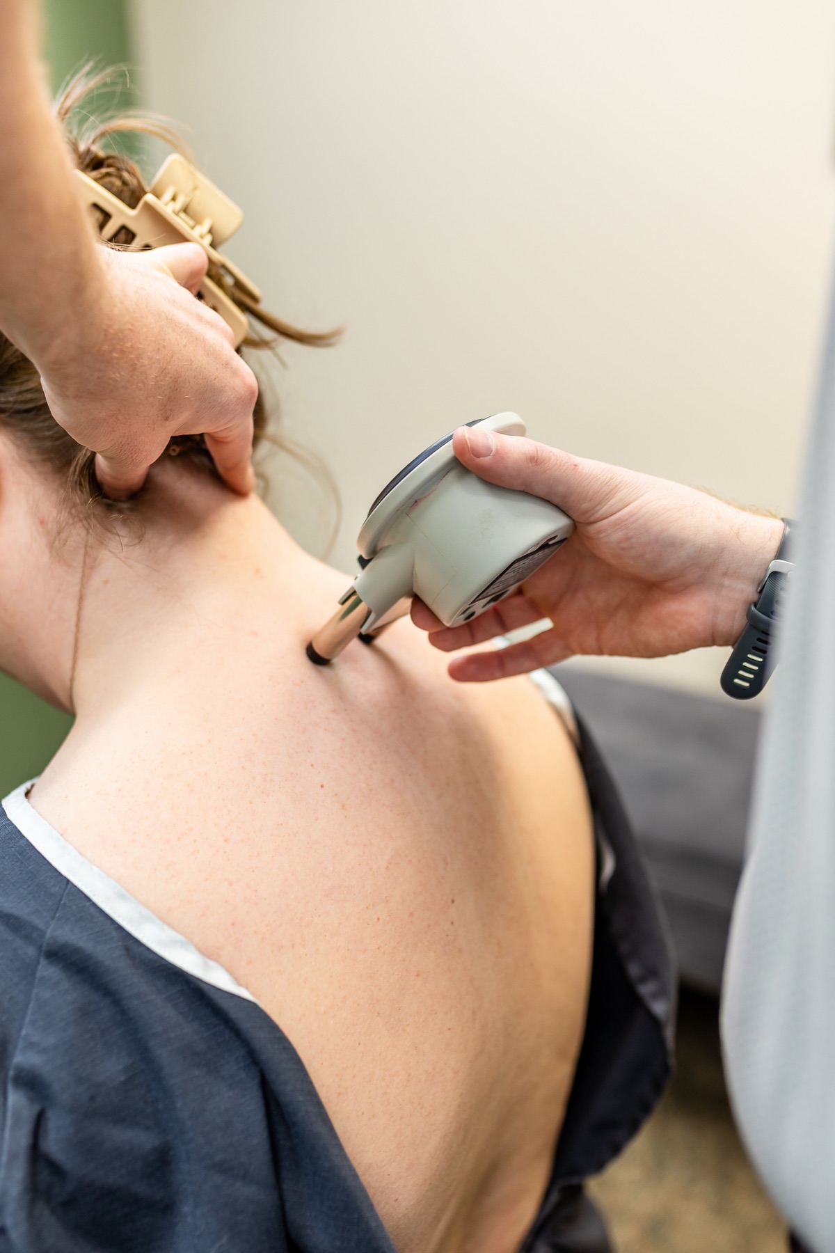 Close-up of the Nervoscope instrument tracing a patient's spine